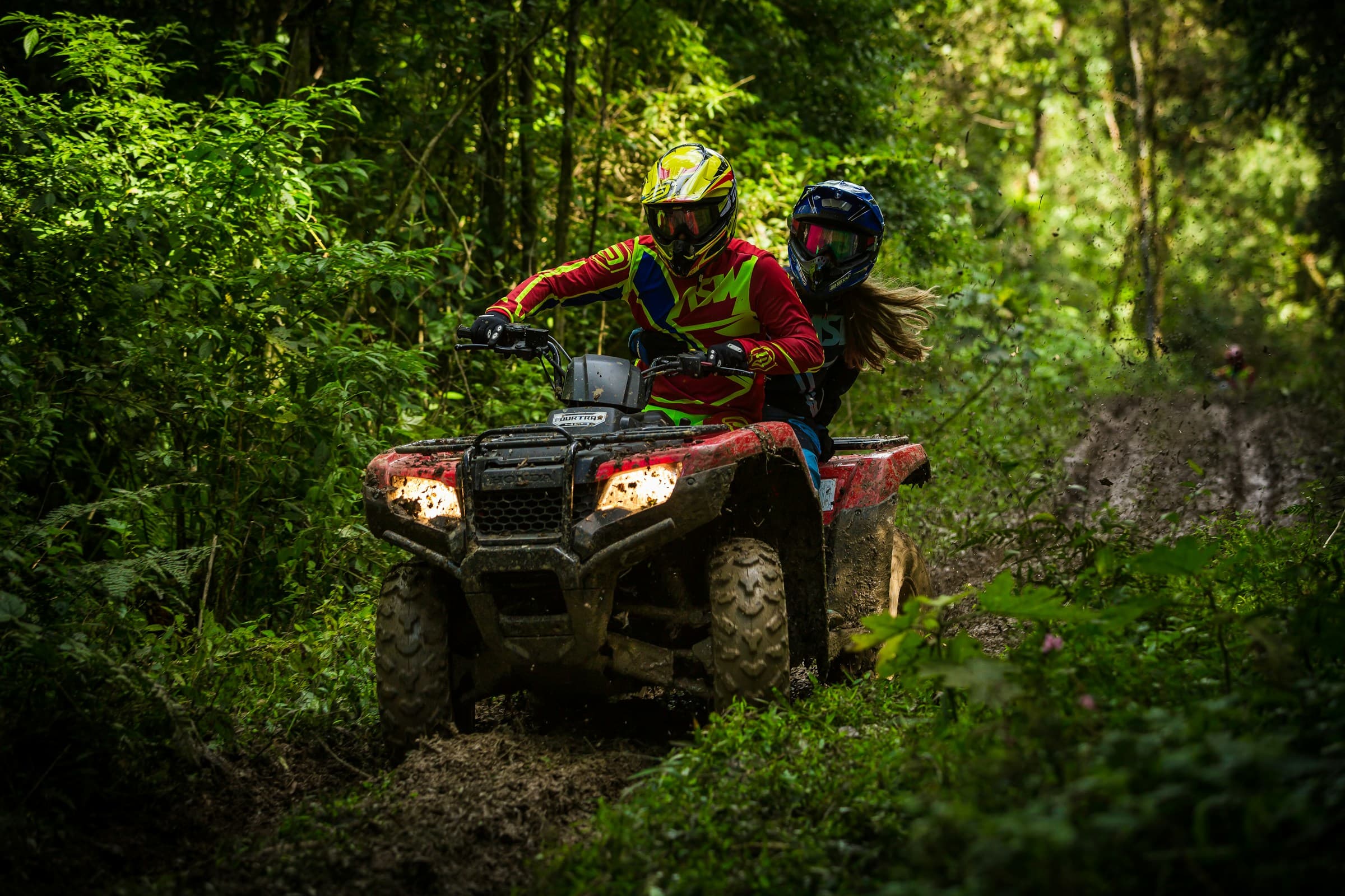 Red ATV on a tropical beach with palm trees
