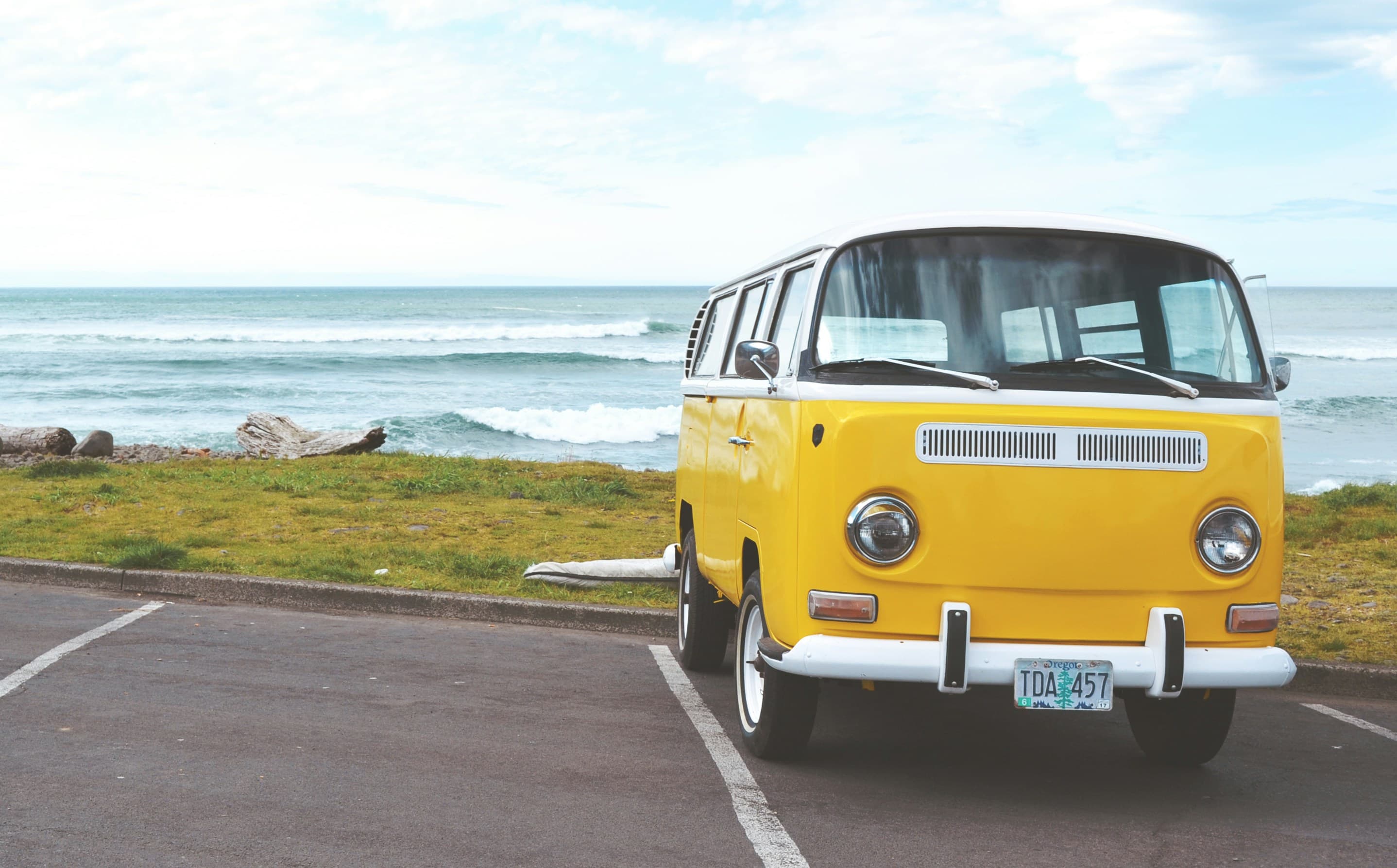 Yellow mini van in front of the sea